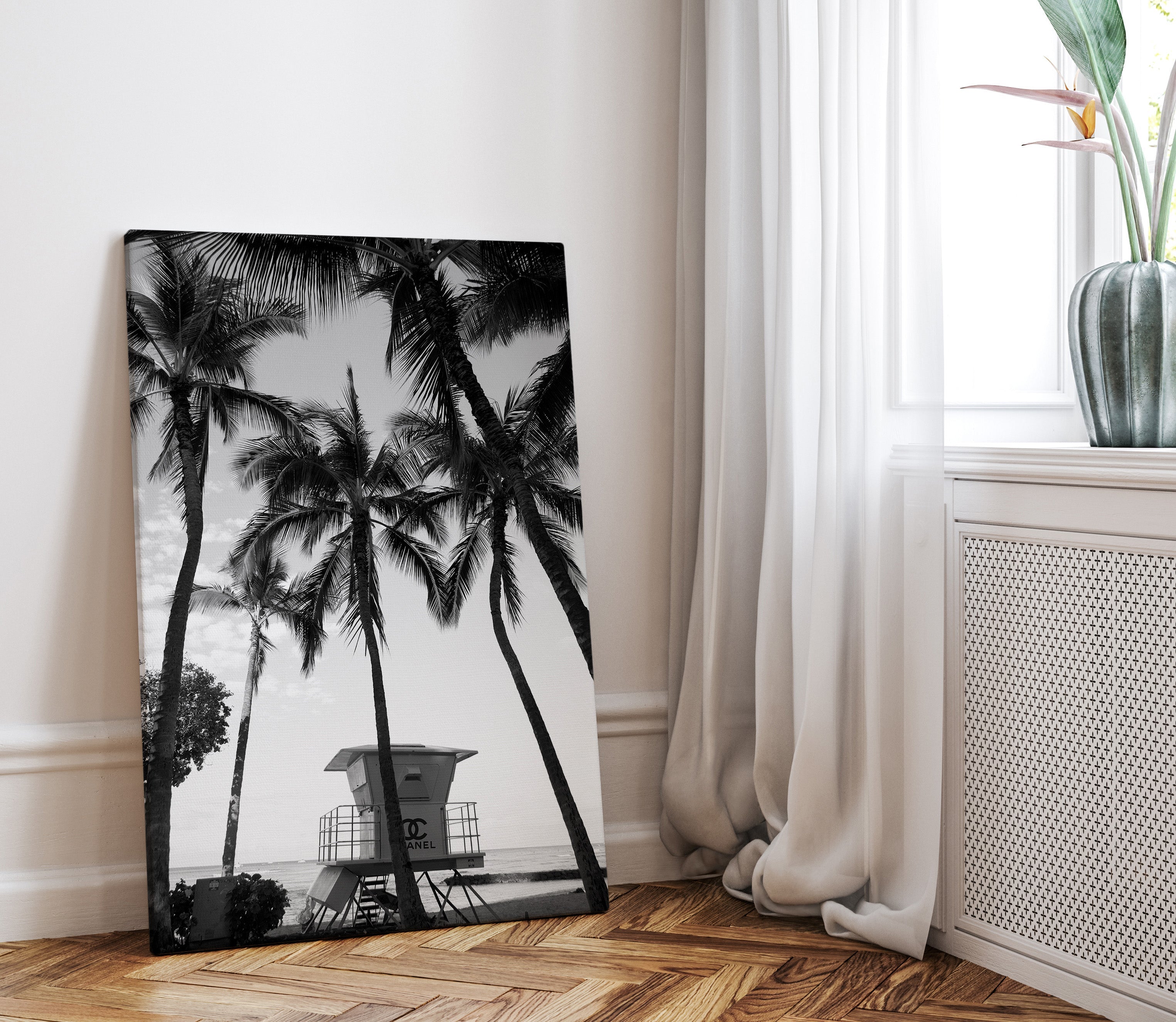 black and whiter canvas print of a chanel lifeguard tower on the beach surrounded by palmtrees