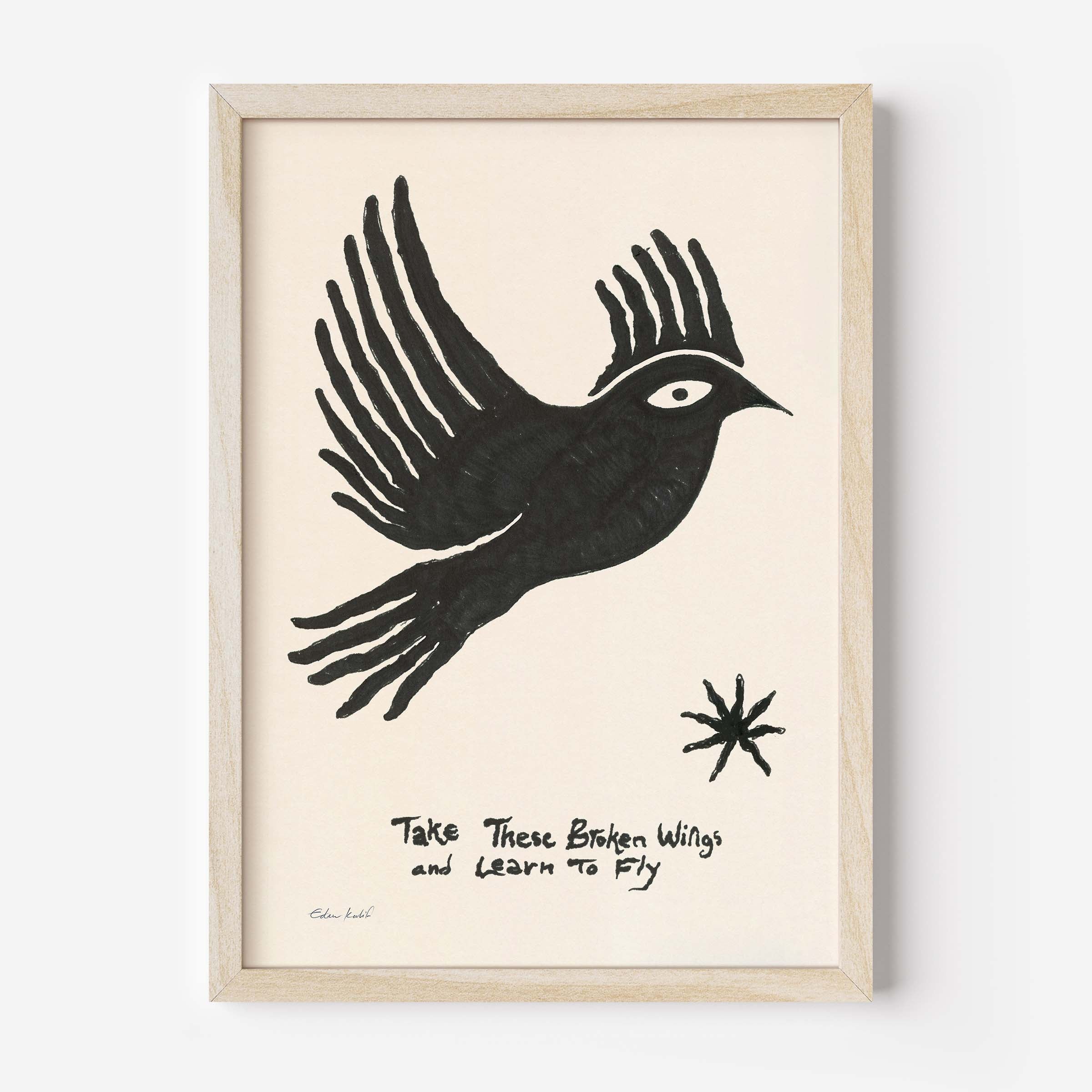 Framed art print by Eden Kalif featuring a bold black hand-drawn bird in flight on a cream background, with the handwritten text "Take These Broken Wings and Learn to Fly" and a small star motif. Printed on 230g matte paper in a black frame.