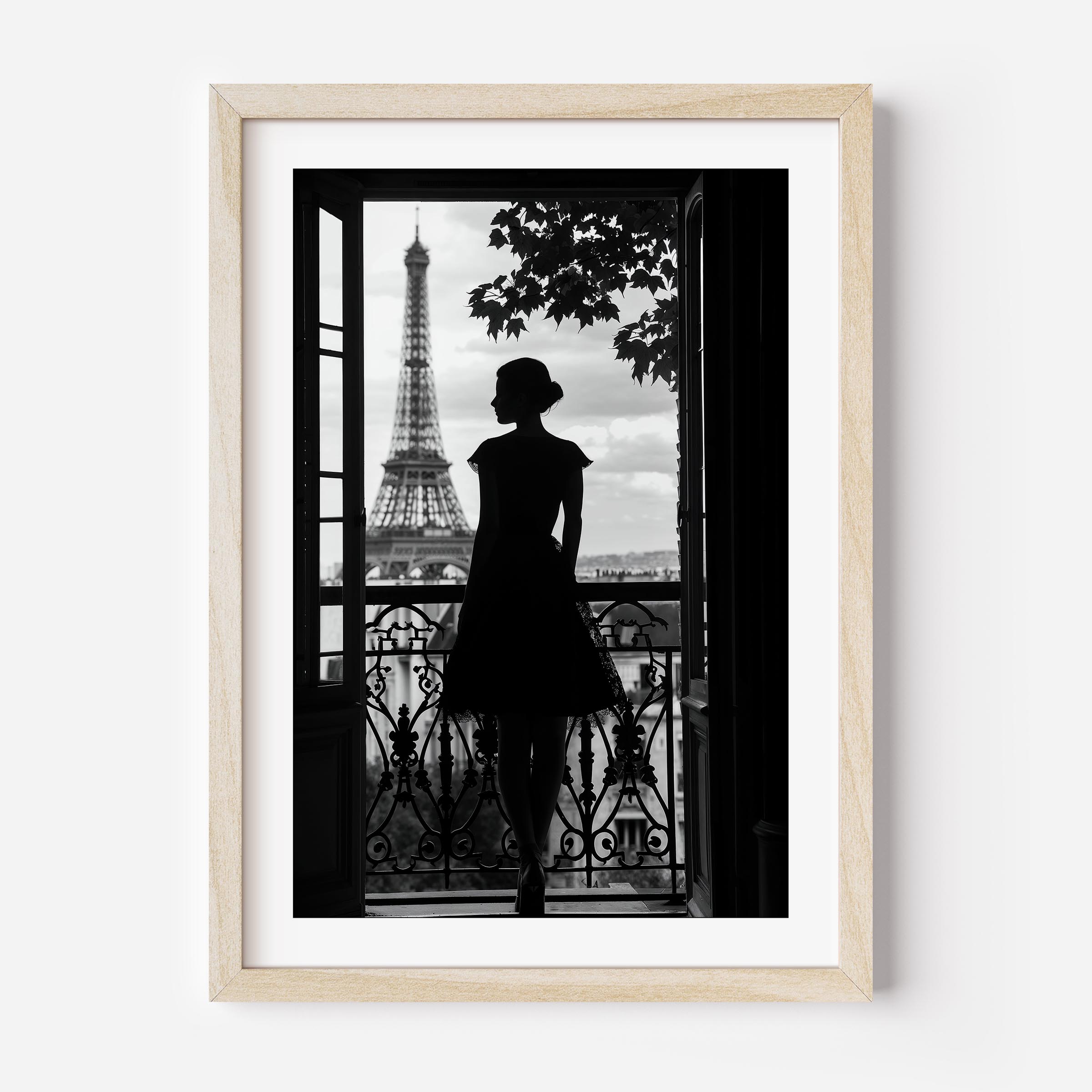 Black-and-white fine art photograph of a woman’s silhouette standing on a Parisian balcony with the Eiffel Tower in the background.