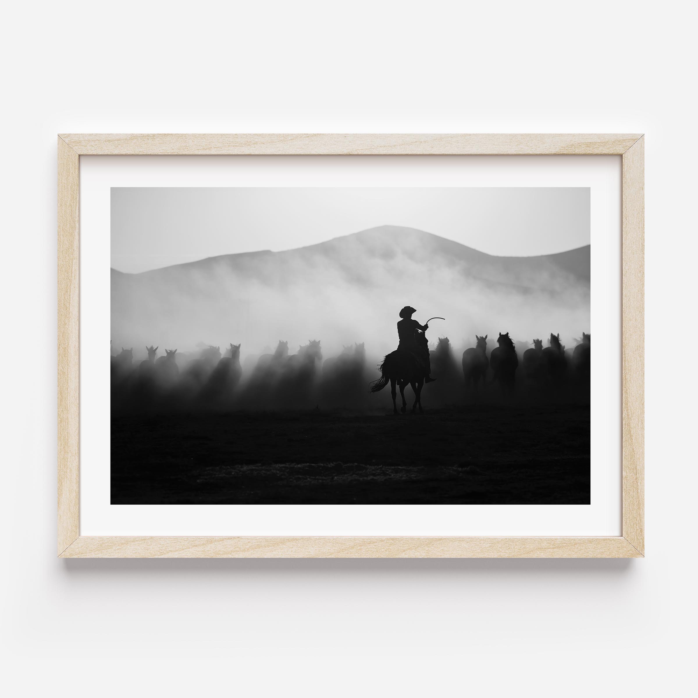 Striking black-and-white cowboy wall art capturing wild horses in motion. Add drama, depth, and Western spirit to your interior with this fine art print.