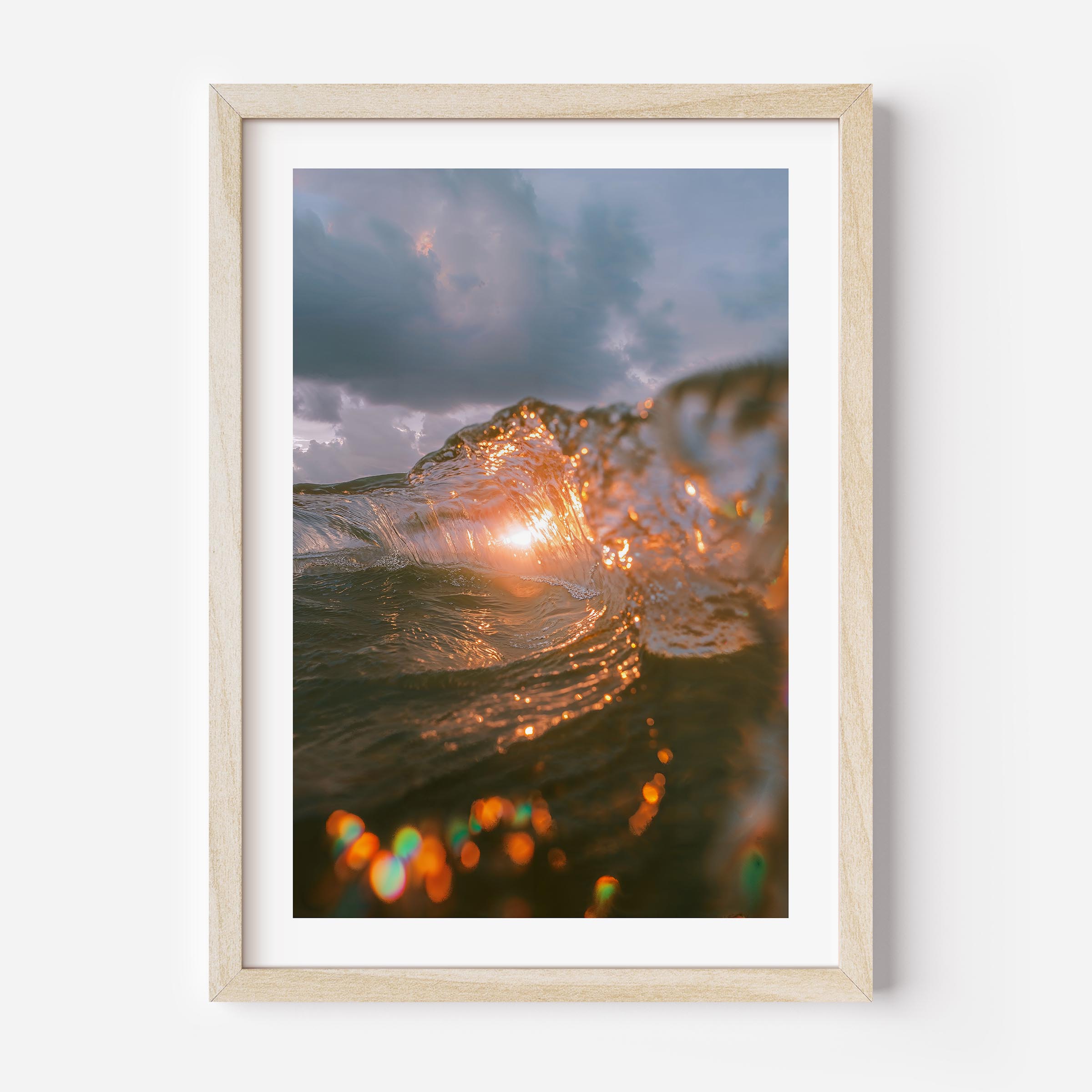 A fine art print of a wave crashing with the sun setting behind it, casting a golden glow on the water. The dynamic motion of the wave is beautifully captured, evoking a sense of energy and tranquility. Ideal for ocean and nature lovers.