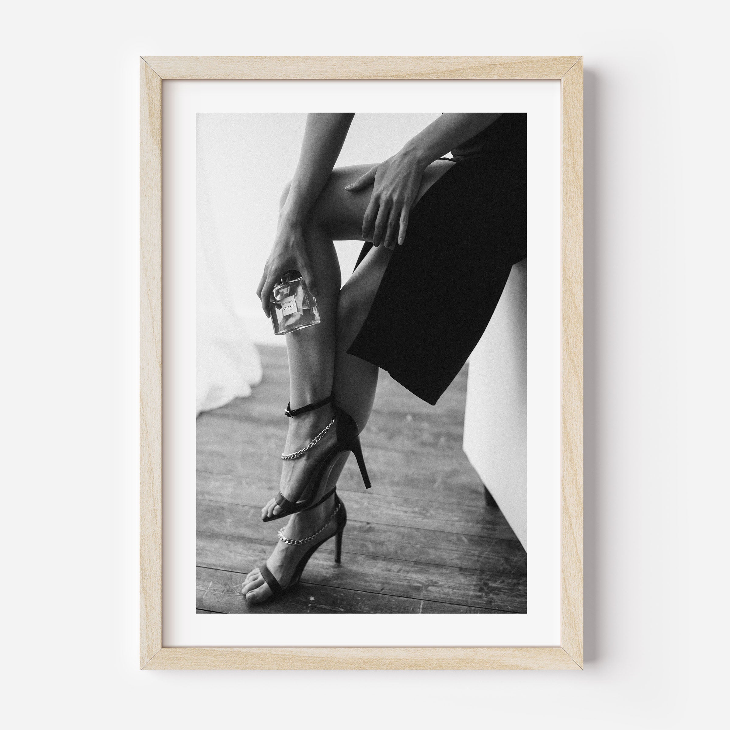 black and white poster of a woman holding a perfume bottle