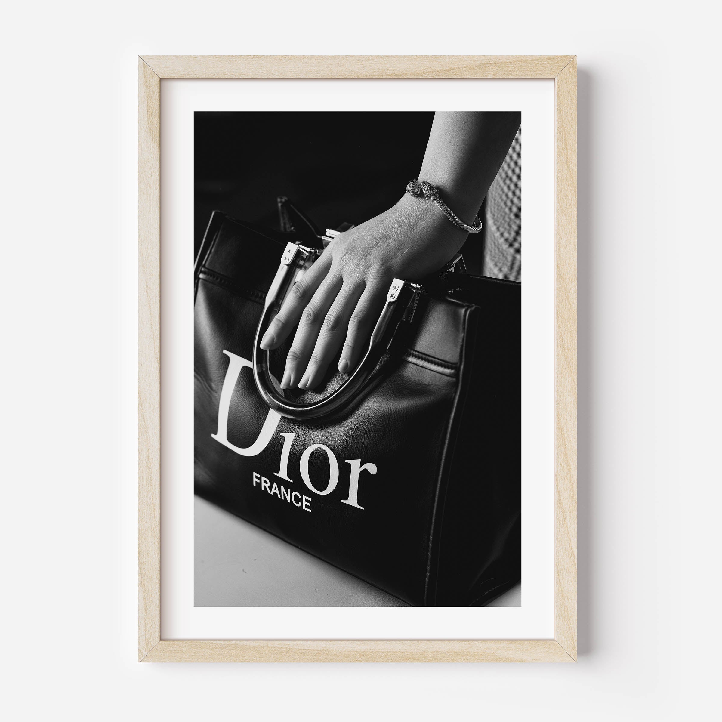 black and white poster of a woman holding a christian dior bag
