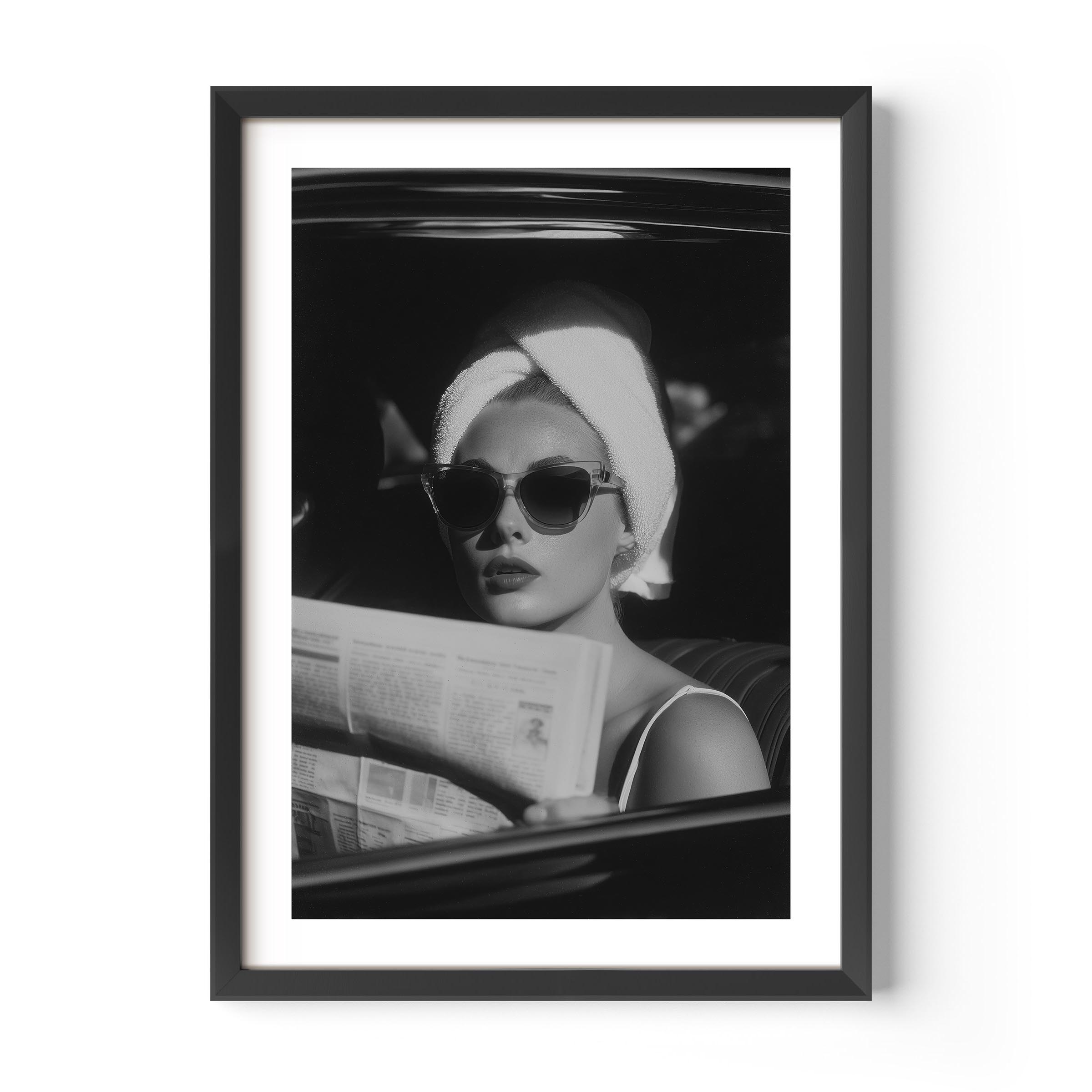 Channel vintage glamour with this black-and-white fine art print of a chic woman in sunglasses reading the paper. Perfect for stylish, fashion-inspired interiors.