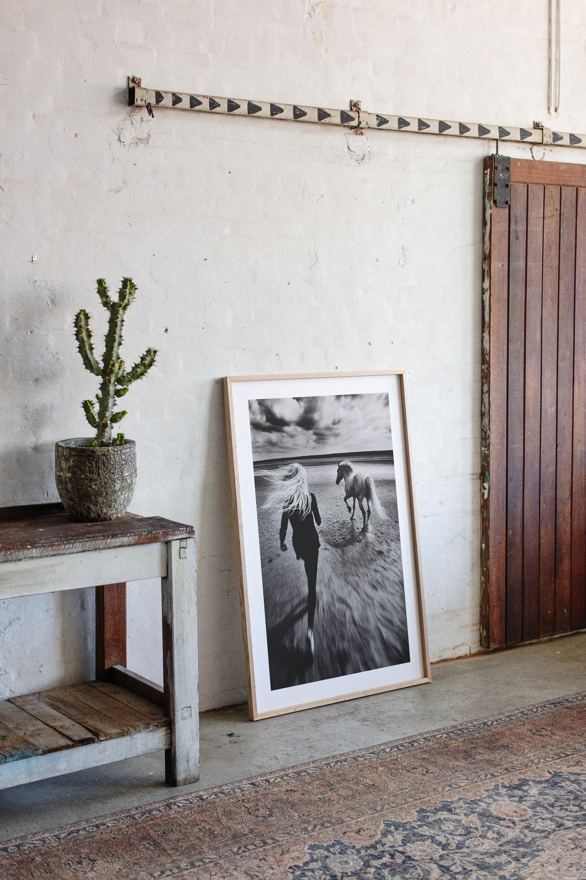 Black and white fine art print of a woman running freely alongside her horse on a vast, empty beach. The image exudes a sense of freedom, movement, and serenity, making it a perfect statement piece for modern, minimalist, or bohemian home decor. With its timeless monochrome tones and elegant composition, this artwork adds depth, sophistication, and a touch of nature’s beauty to any interior space.