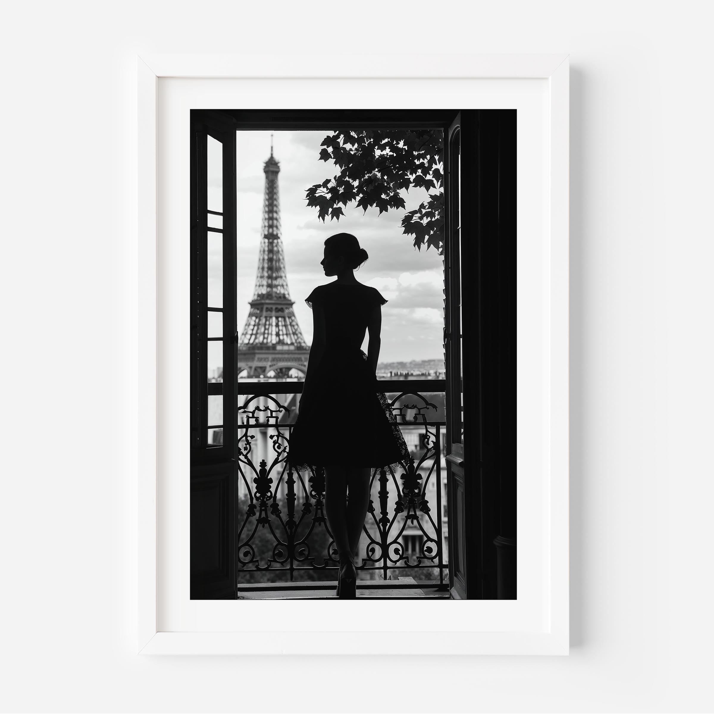 Black-and-white fine art photograph of a woman’s silhouette standing on a Parisian balcony with the Eiffel Tower in the background.