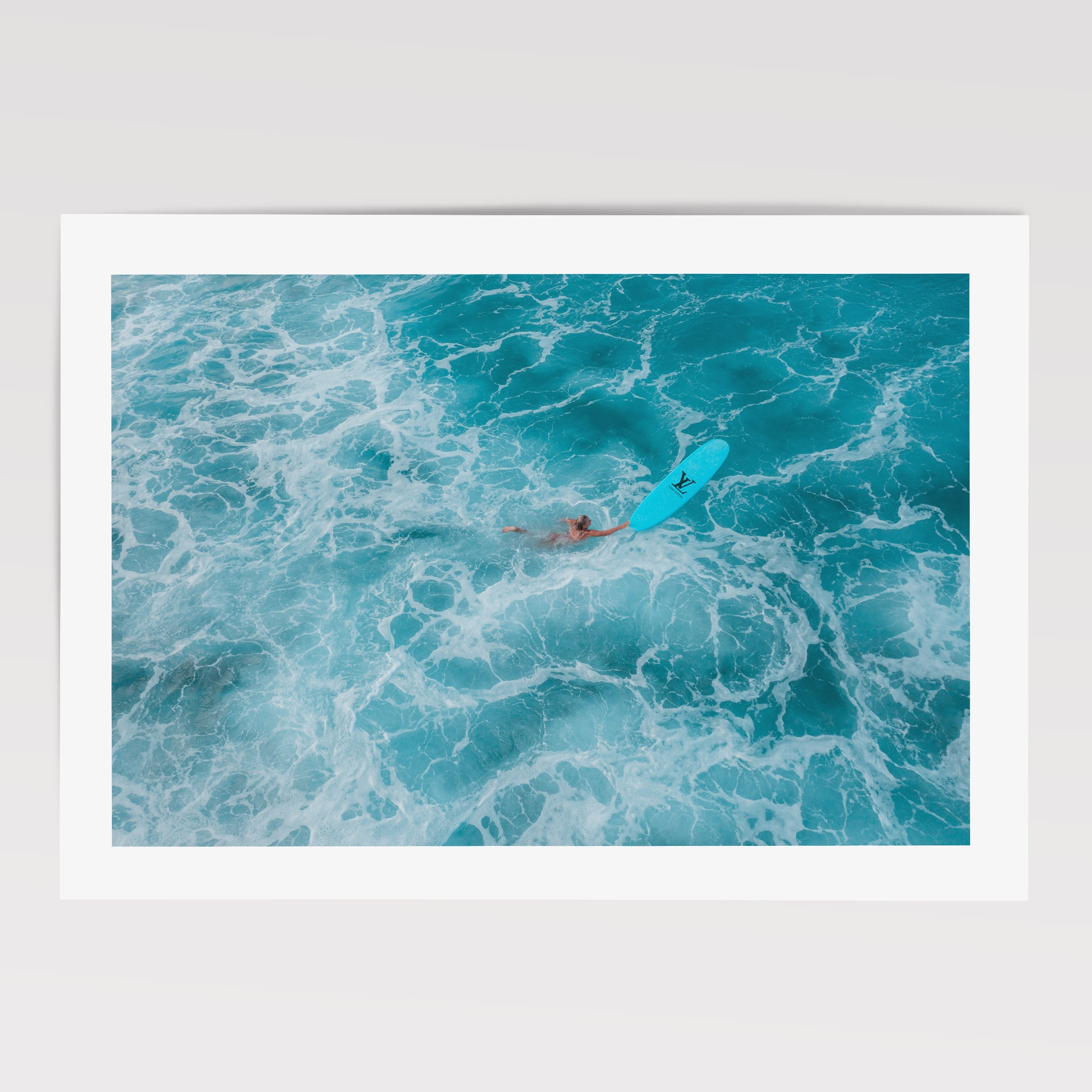 woman swimming with surfboard in clear blue water poster/ wall art