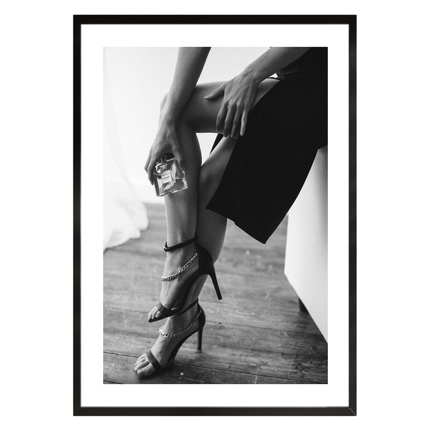 black and white poster of a woman holding a perfume bottle