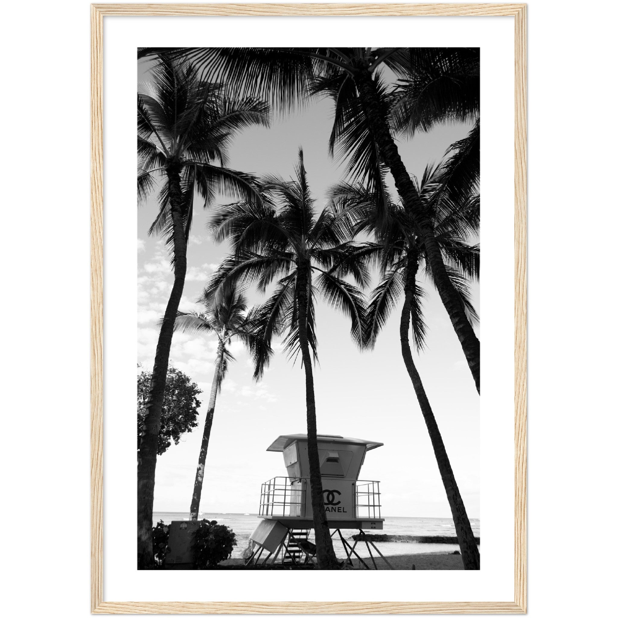 black and white poster of a chanel lifeguard tower on a beach surrounded by plamtrees