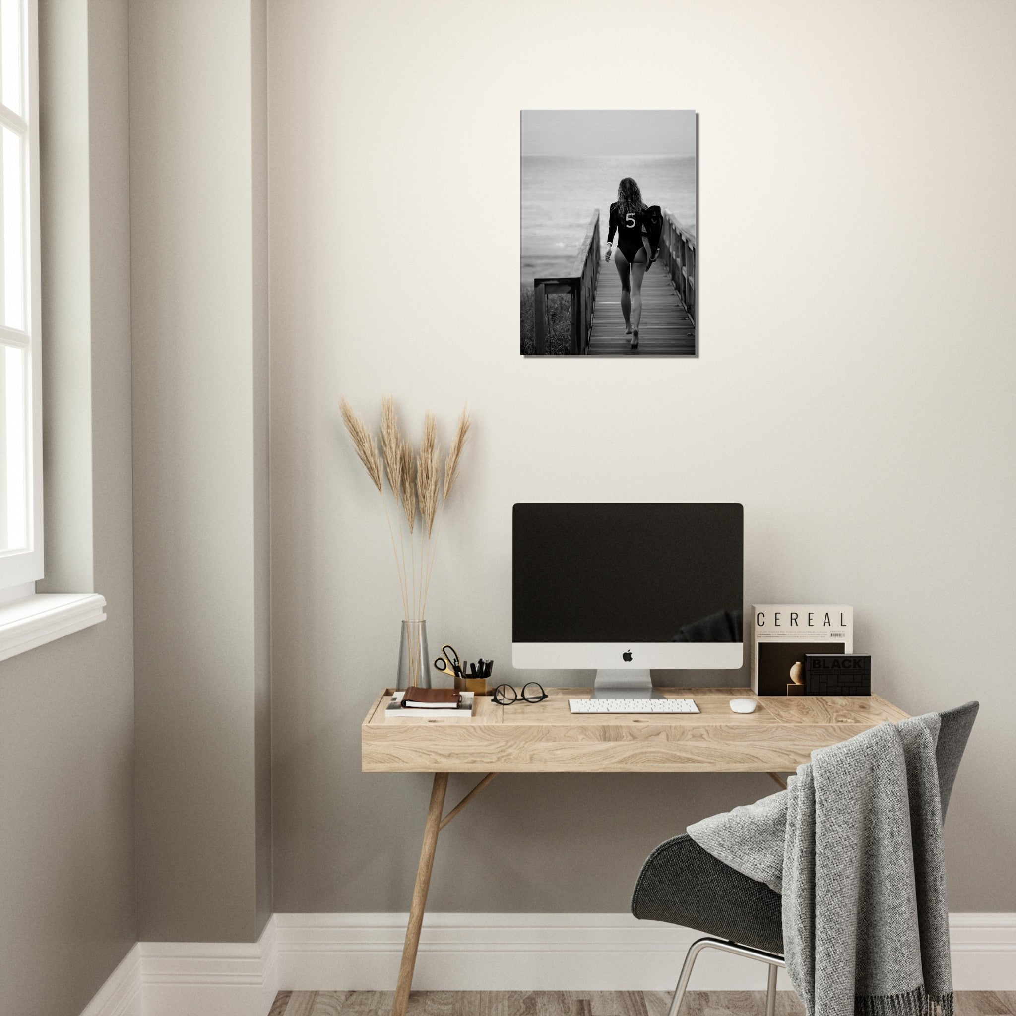 black and white canvas print of a woman in bathing suit ready to go surfing. ther eis a print of the coco chanel nr 5 on the bathing suit