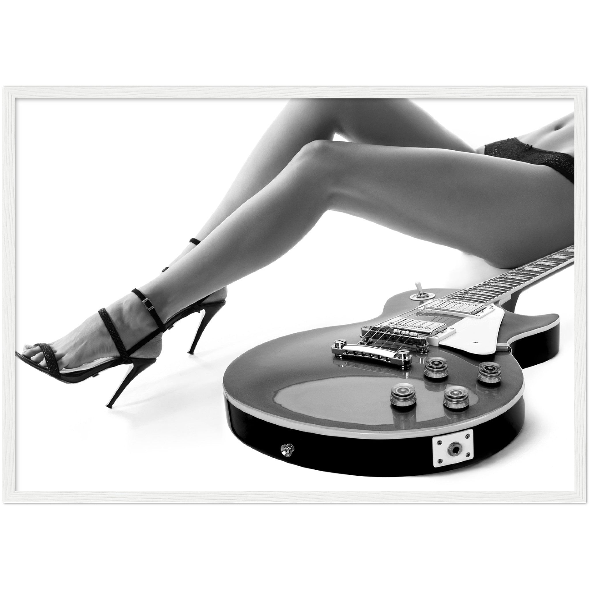 black and white framed poster of a sexy woman lying next to an electric guitar