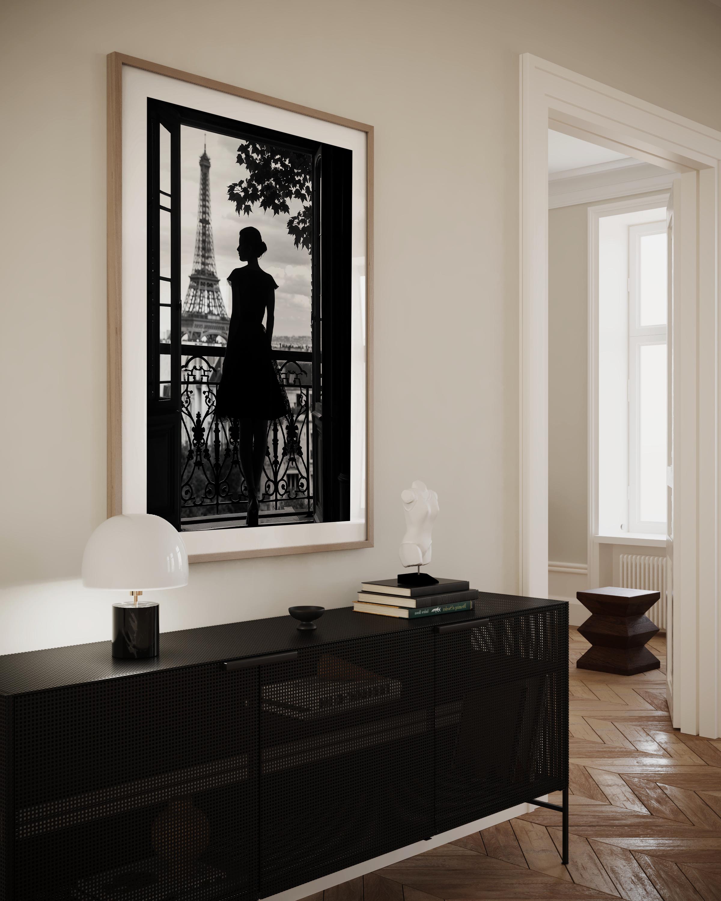 Black-and-white fine art photograph of a woman’s silhouette standing on a Parisian balcony with the Eiffel Tower in the background.