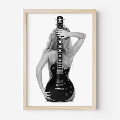 Black-and-white fine art print of a figure from behind holding an electric guitar on a white background.