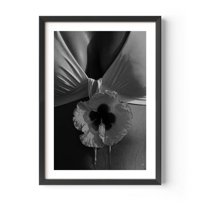 Black-and-white close-up photo print featuring a hibiscus flower against draped fabric and sunlit skin with water droplets.