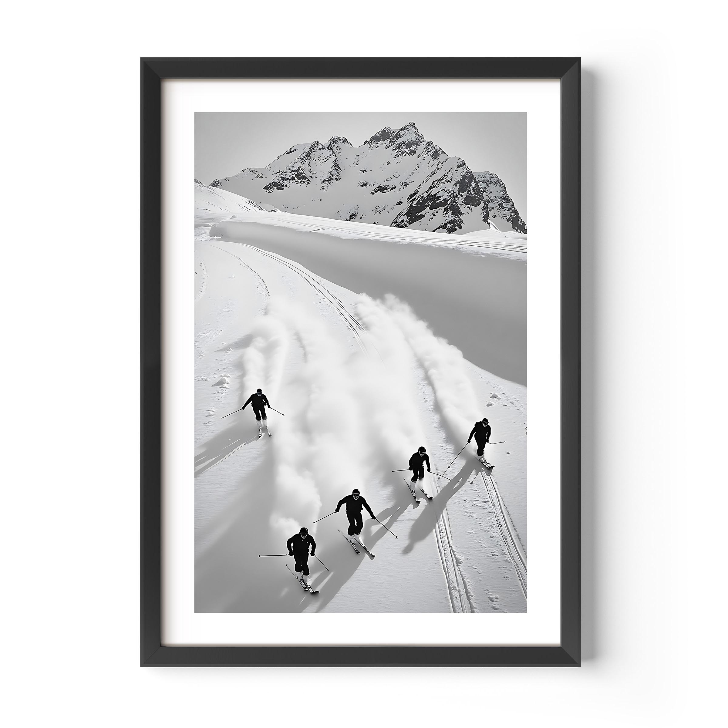 Black and white fine art print of five skiers carving through snow with mountains in the background, framed in black.