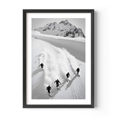 Black and white fine art print of five skiers carving through snow with mountains in the background, framed in black.