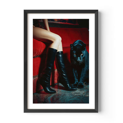 Luxury art print featuring a black panther and woman in boots on a red velvet sofa. Bold, sensual, and stylish wall art for modern interiors.