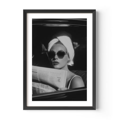 Channel vintage glamour with this black-and-white fine art print of a chic woman in sunglasses reading the paper. Perfect for stylish, fashion-inspired interiors.