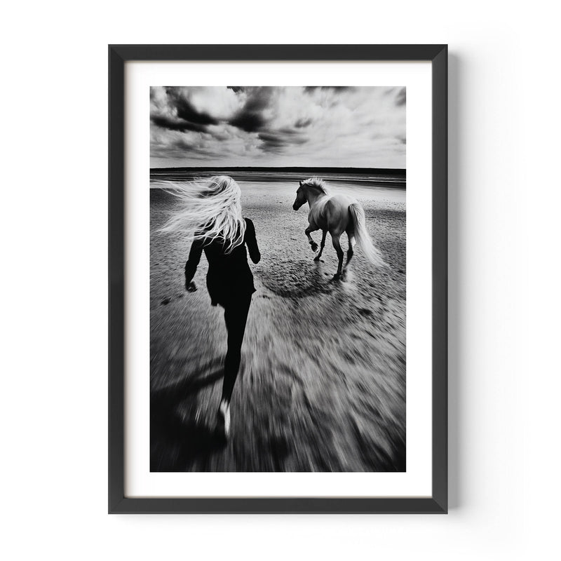 Black and white fine art print of a woman running freely alongside her horse on a vast, empty beach. The image exudes a sense of freedom, movement, and serenity, making it a perfect statement piece for modern, minimalist, or bohemian home decor. With its timeless monochrome tones and elegant composition, this artwork adds depth, sophistication, and a touch of nature’s beauty to any interior space.