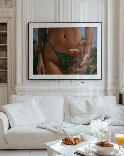 Framed fine-art photograph of a woman in an emerald snakeskin bikini holding a cocktail with a watermelon garnish; summer fashion editorial by Britt Van der Meyden.