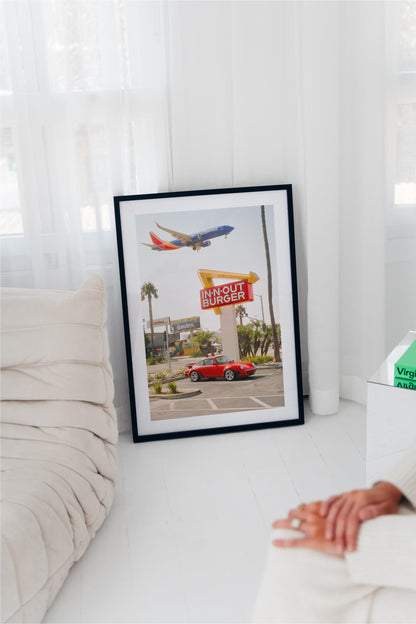 Red Porsche parked at In-N-Out Burger with airplane flying overhead – fine art wall print by Deston Isas