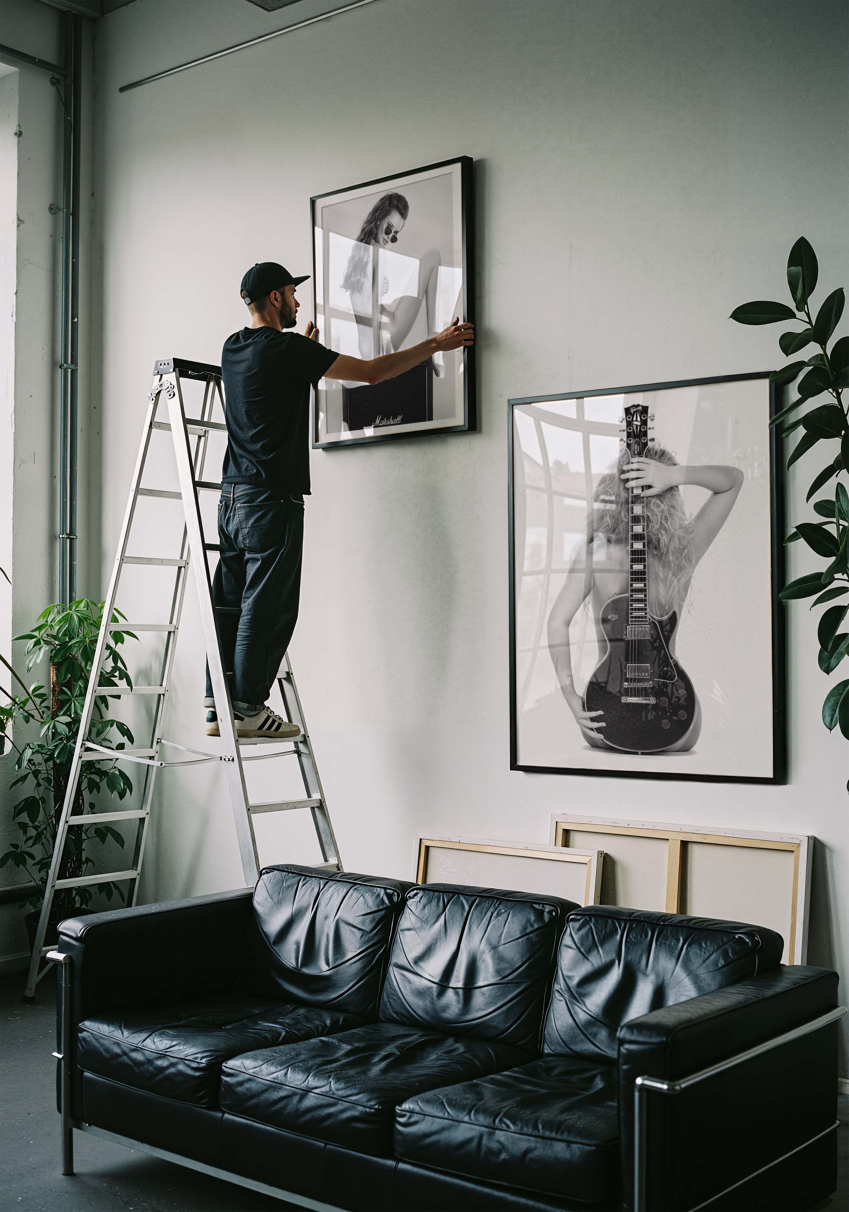 Black-and-white fine art print of a figure from behind holding an electric guitar on a white background.