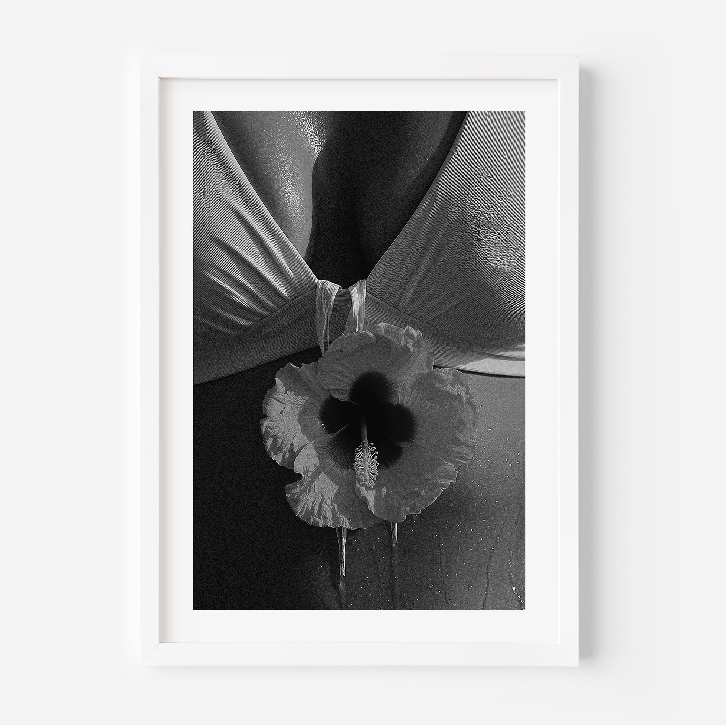 Black-and-white close-up photo print featuring a hibiscus flower against draped fabric and sunlit skin with water droplets.