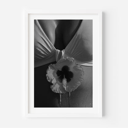 Black-and-white close-up photo print featuring a hibiscus flower against draped fabric and sunlit skin with water droplets.