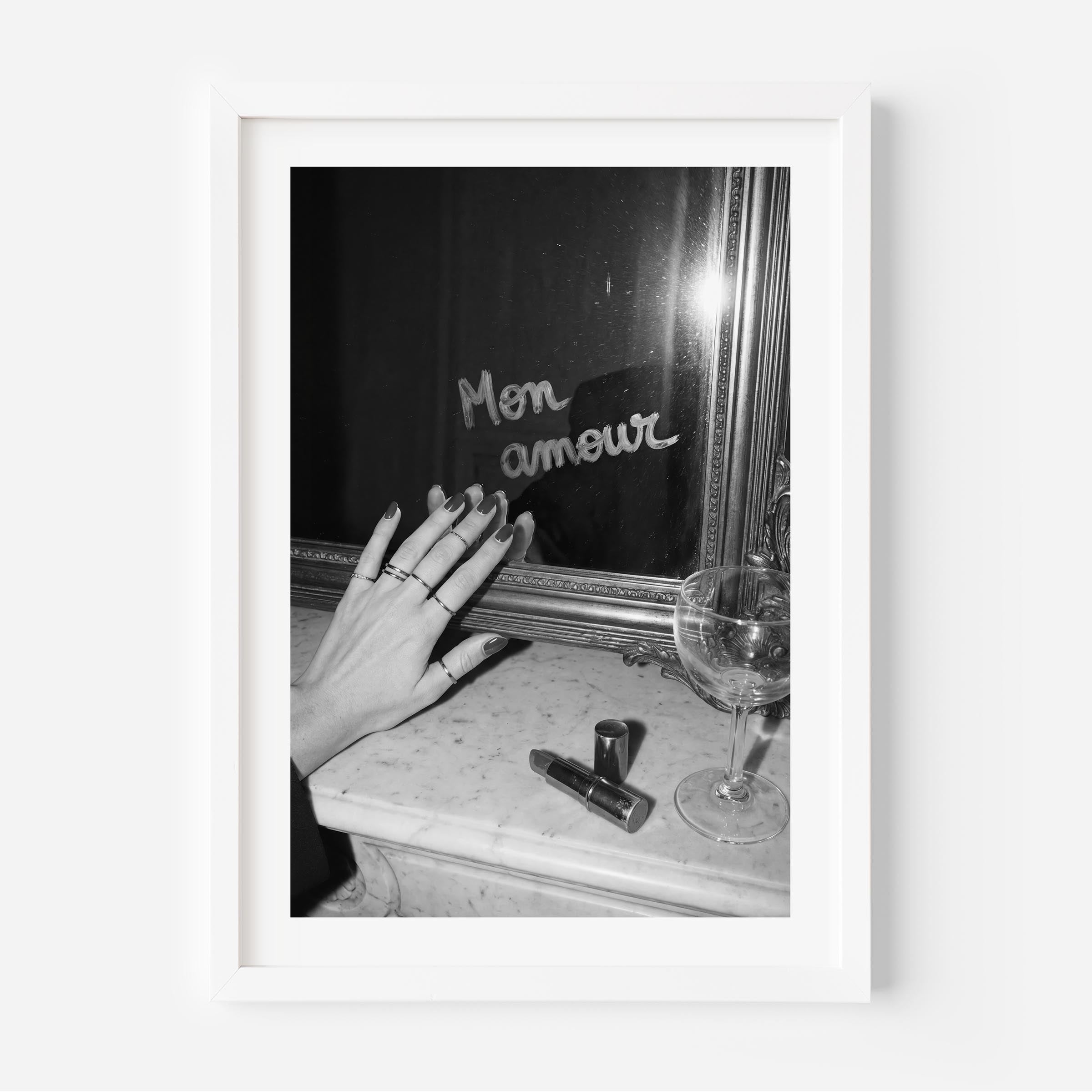 Framed black and white photo of a hand reaching towards a mirror with 'Mon amour' text.