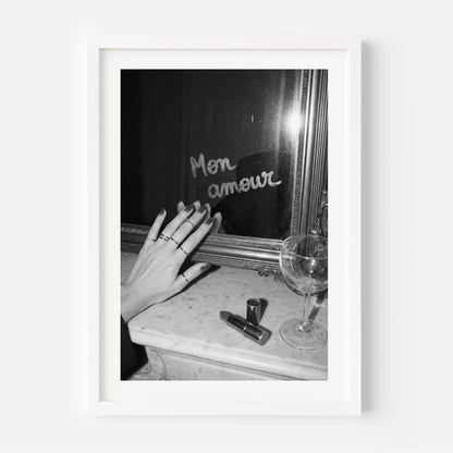 Framed black and white photo of a hand reaching towards a mirror with 'Mon amour' text.