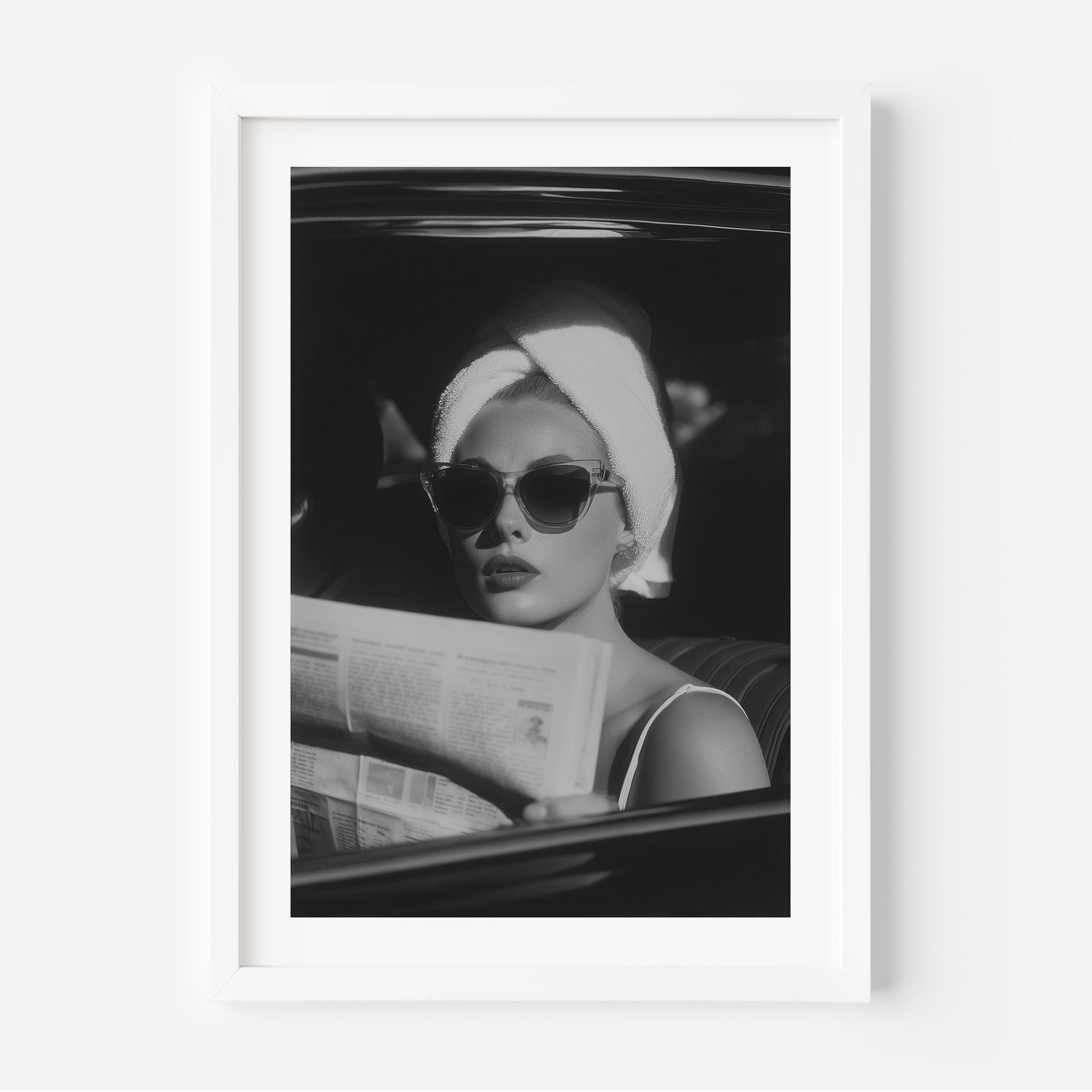 Channel vintage glamour with this black-and-white fine art print of a chic woman in sunglasses reading the paper. Perfect for stylish, fashion-inspired interiors.