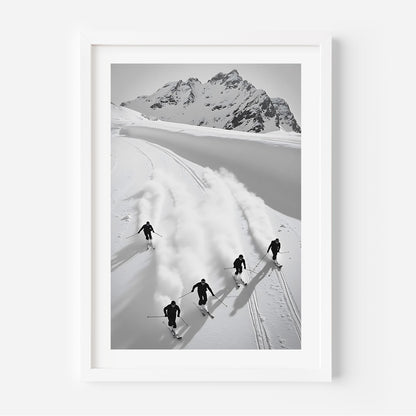 Black and white fine art print of five skiers carving through snow with mountains in the background, framed in black.