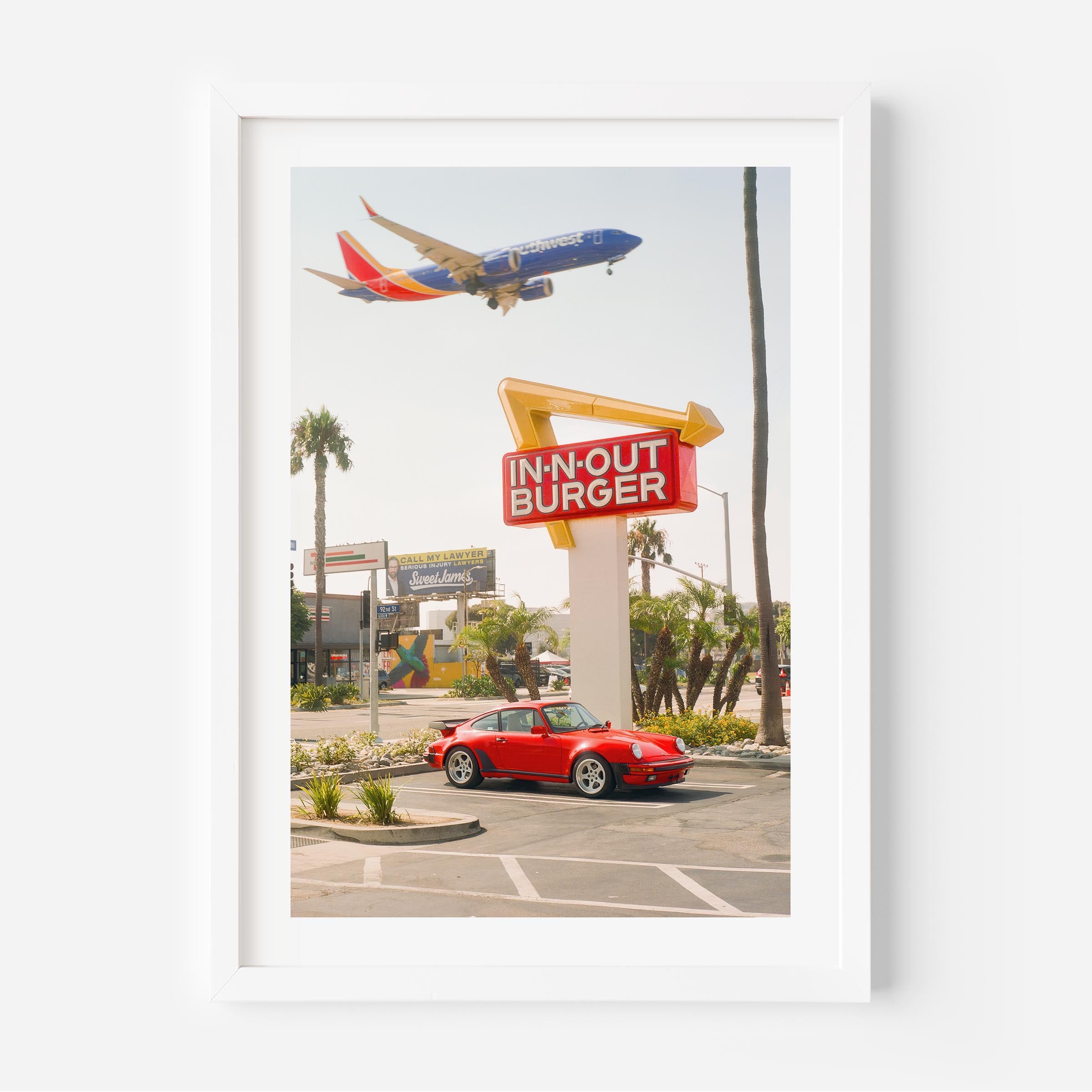 Red Porsche parked at In-N-Out Burger with airplane flying overhead – fine art wall print by Deston Isas