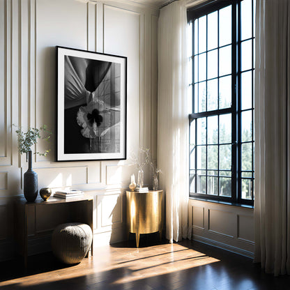 Black-and-white close-up photo print featuring a hibiscus flower against draped fabric and sunlit skin with water droplets.