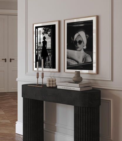 Channel vintage glamour with this black-and-white fine art print of a chic woman in sunglasses reading the paper. Perfect for stylish, fashion-inspired interiors.
