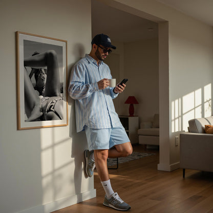 Black-and-white photo of two women relaxing poolside; foreground legs frame a seated figure in a zebra-print top, by Britt van der Meijden