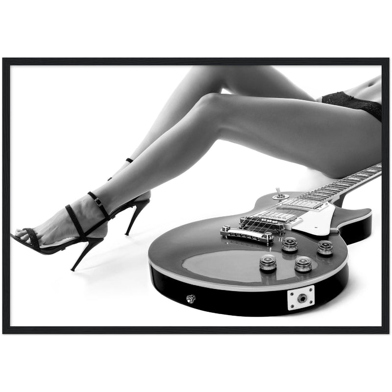black and white framed poster of a sexy woman lying next to an electric guitar