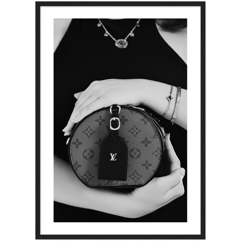 black and white poster of a woman holding a louis vuitton designer handbag