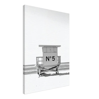 black and white canvas of a cabin on the beach with the iconick chanel number 5 on it