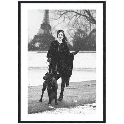 black and white poster of a woman posing with her dog in front of the Eiffel Tower